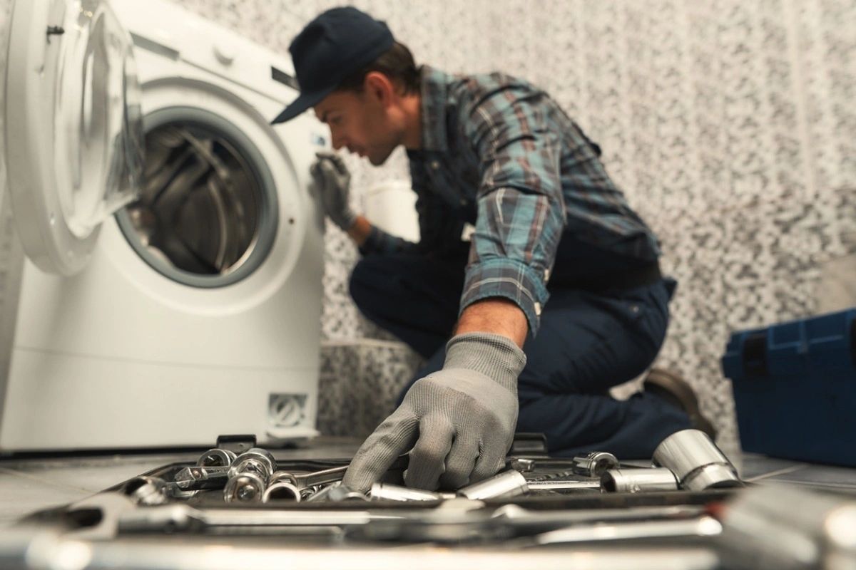 Alliance Appliance Repair technician diagnosing a kitchen appliance